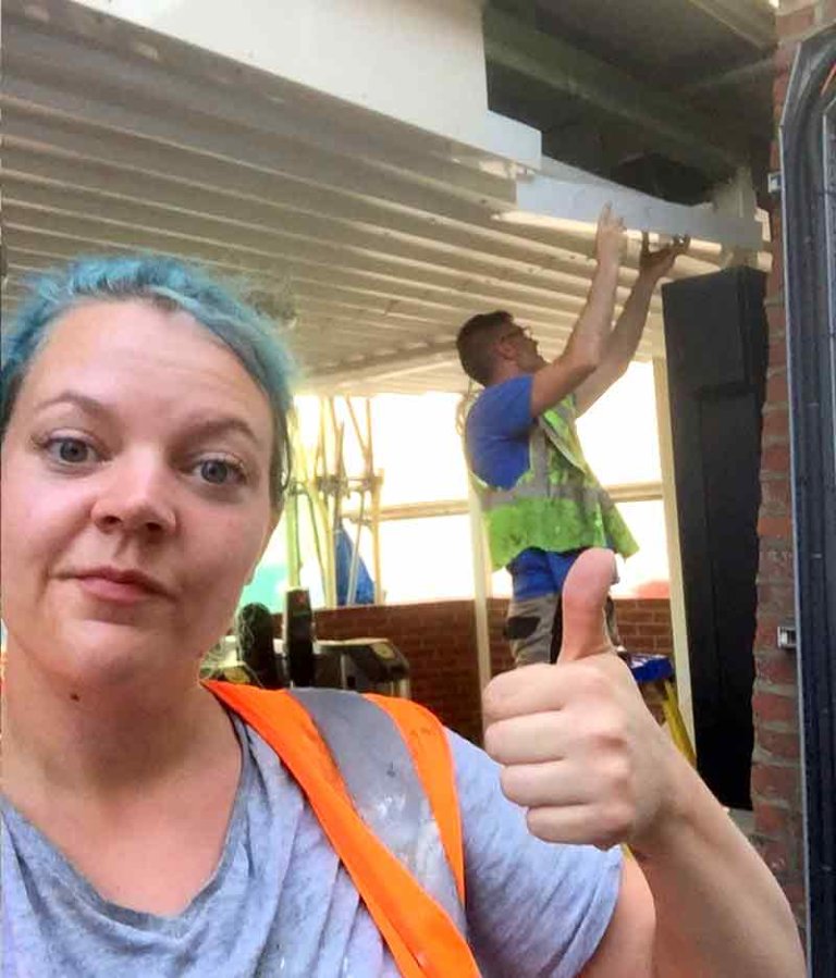 Gemma on a worksite giving the thumbs up