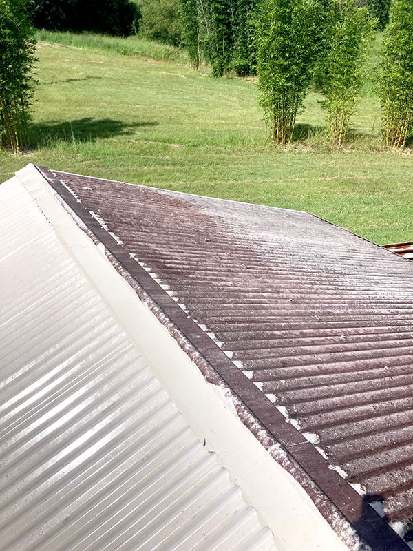 A roof that is very dirty on one side and clean on the other